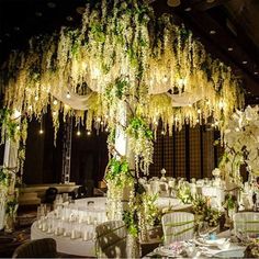 an elaborately decorated dining room with chandeliers and flowers