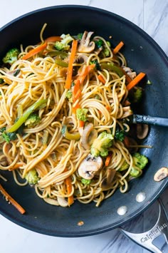 pasta with mushrooms, broccoli and carrots in a skillet