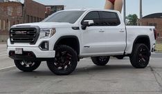 a woman standing on top of a white truck