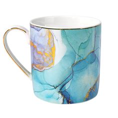 a blue and yellow coffee cup with gold trim