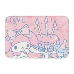 a pink hello kitty tray with candles and a cat on it's side, in front of a white background