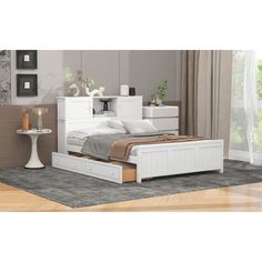 a white bed sitting on top of a wooden floor