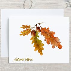 an autumn card with watercolor leaves and acorns