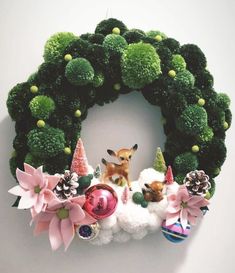 a christmas wreath with ornaments and deer on it