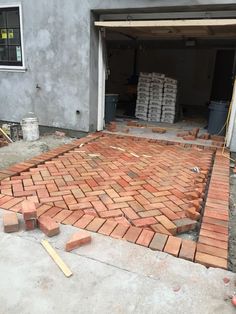 a brick walkway being built in front of a garage