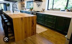 a large kitchen with an island in the middle and lots of counter space on one side