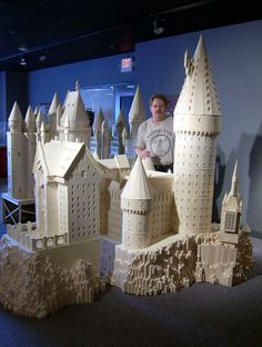 a man standing in front of a model of a castle made out of legos