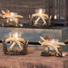 three candles sitting on top of a wooden box