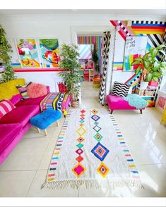 a brightly colored living room with colorful couches and rugs on the floor,