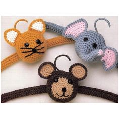 three crocheted mouses and a rat hanging on a wall