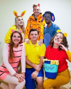 a group of people in costumes posing for a photo