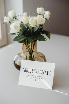 white roses in a vase with a card that says girl, you know