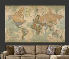 an old world map is hanging on the wall above a couch in a living room