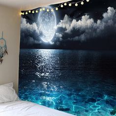 a bed room with a large wall hanging next to a window