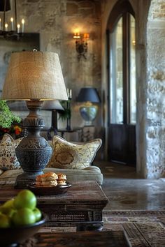 a living room filled with furniture and a lamp on top of a wooden coffee table