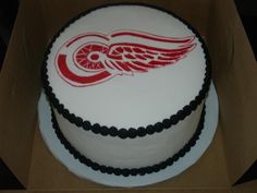 a white cake with red wings on it