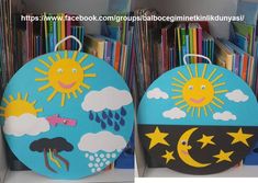 two paper plates with pictures of the sun and moon on them in front of bookshelves