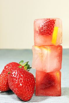 some strawberries and ice cubes on a table