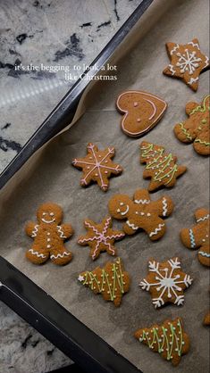 gingerbread cookies decorated with icing and sprinkles on a baking sheet