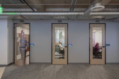 three doors are open in an office building