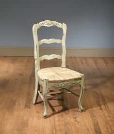 a white chair sitting on top of a hard wood floor next to a wooden floor