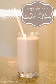 a glass filled with milk sitting on top of a counter