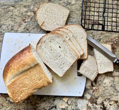 slices of white bread sitting on top of a cutting board