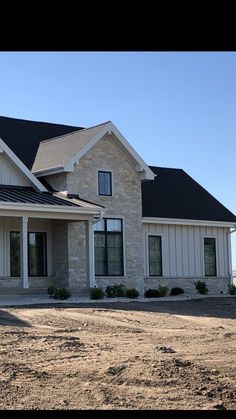 a large house sitting on top of a dirt field