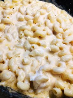 macaroni and cheese is being cooked in a skillet