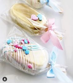 two pastries wrapped in plastic with bows on them