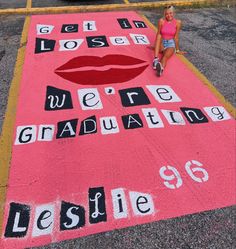 a woman sitting on top of a pink rug with words written in black and white