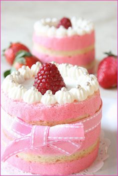 two small cakes with strawberries on top