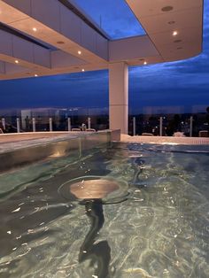 an indoor swimming pool with clear water at night