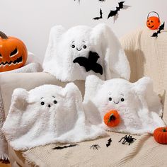 three white towels with halloween decorations on them