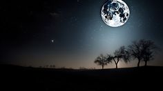 an image of the moon in the night sky with trees and stars on it's horizon