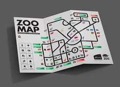 an open brochure showing the location of zoo maps on it's front cover