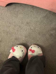 someone wearing hello kitty slippers on their feet