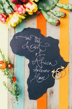 a sign that says, in the heart of africa forever love on it next to some flowers