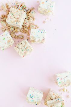 pieces of cake and sprinkles on a pink surface