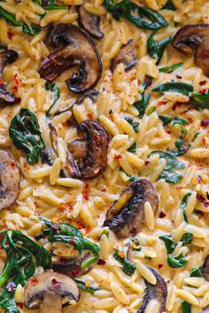 pasta with mushrooms, spinach and cheese in a pan