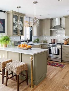 a kitchen island with two stools in front of it and an oven on the other side