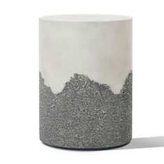 a white and grey vase with some black speckles on it