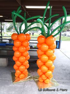 two carrots made out of balloons sitting on the ground