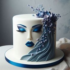 a close up of a cake on a table with blue and white frosted decorations