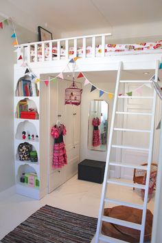 there is a bunk bed with a ladder in the room and shelves on the wall