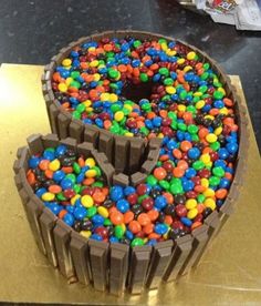 a large chocolate cake with candy in the shape of a heart