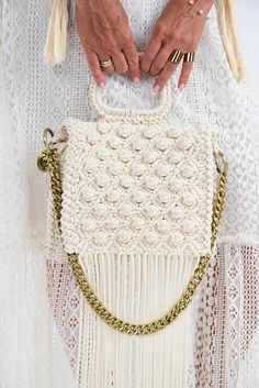 Description Introducing the pinnacle of boho-chic elegance: the Off-White Fringe Crochet Handbag. Handcrafted with meticulous care, this stunning piece seamlessly combines timeless sophistication with a playful charm. Versatile and stylish, this handbag transitions effortlessly from day to night, perfectly complementing your favorite cocktail dress. Whether you're enjoying champagne at a rooftop party or exploring an art gallery, this handbag makes the perfect statement piece, elevating your loo Fringe Crochet, Rooftop Party, Fringe Handbags, Crochet Handbag, White Fringe, Trendy Handbags, Handmade Handbags, How To Make Handbags, Chic Handbags