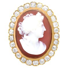 A stunning, fine and impressive antique hardstone and 4.88 carat diamond, 18 karat yellow gold cameo brooch; part of our diverse antique jewelry and estate jewelry collections This stunning, fine and impressive antique brooch with diamonds has been crafted in 18k yellow gold. The oval shaped frame is ornamented to the centre with a stunning cameo upon a hardstone background. The cameo depicts a female figure in profile. The hardstone panel is framed by twenty-six fine and impressive individually set Old European cut diamonds, totalling 4.88Cts. The brooch secures to the reverse with a detachable hinged pin and clasp fastening; if required, a ring loop could be added to this impress brooch enabling it to be worn as a pendant. This antique cameo brooch with diamonds has been independently te Diamond Ribbon, Vintage Fine Jewelry, Wreath Decoration, Gold Locket, Antique Brooches, Diamond Brooch, Female Figure, Cameo Brooch, Gold Brooches