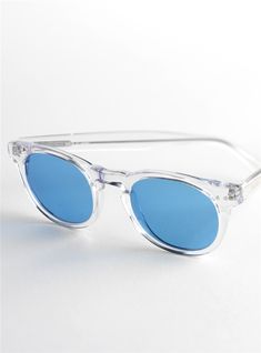 Semi-round Sunglasses in Clear with Blue Lenses - The Ben Silver Collection Sunglasses Blue Lenses, Round Sunglasses With Mirrored Lenses And Glass, Classic Blue Sunglasses With Uv Protection, Modern Round Clear Sunglasses, Round Glass Sunglasses With Tinted Lenses, Classic Blue Glass Sunglasses, Round Tinted Glass Sunglasses, Modern Round Glass Sunglasses, Blue Round Frame Sunglasses With Mirrored Lenses