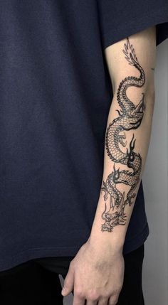 a man with a dragon tattoo on his arm